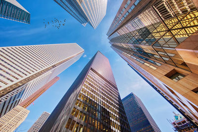 Low angle view of modern buildings against sky in city