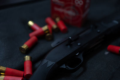 Close-up of gun and bullets on table