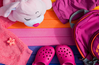 Directly above shot of baby clothing with backpack and booties on table