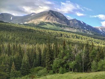 Scenic view of mountains against cloudy sky