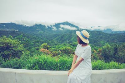 Woman standing on mountain road