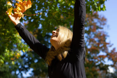 Low angle view of woman walking on tree