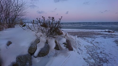 Scenic view of sea against sky during winter