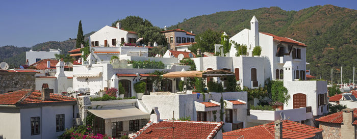 Houses in city against clear sky
