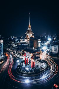 High angle view of light trails on road against buildings