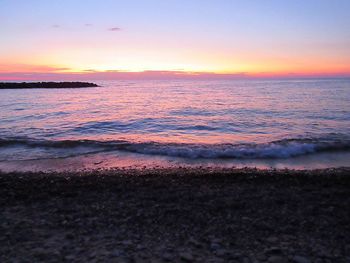 Scenic view of sea against romantic sky at sunset