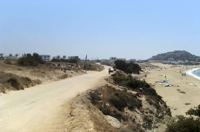 Road on beach against clear sky