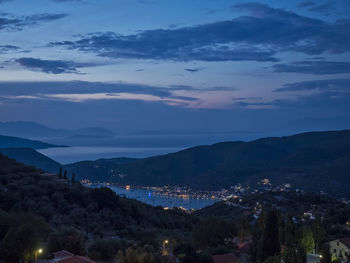 High angle view of illuminated townscape against sky at dusk