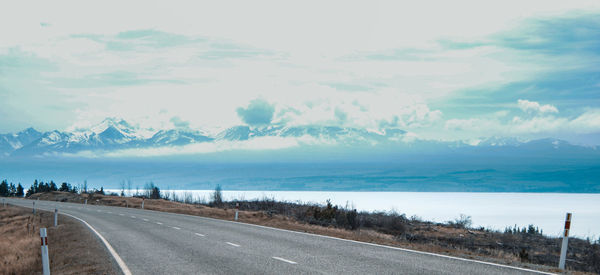 Road by sea against sky