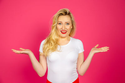 Portrait of woman against red background