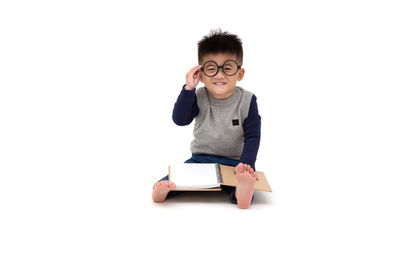 Portrait of boy against white background