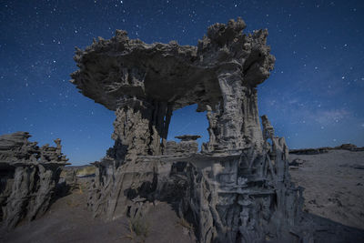Low angle view of tufa against star field