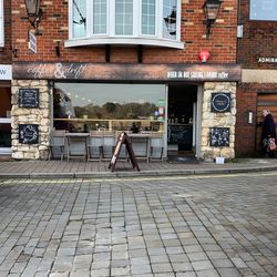 Man on footpath by building in city