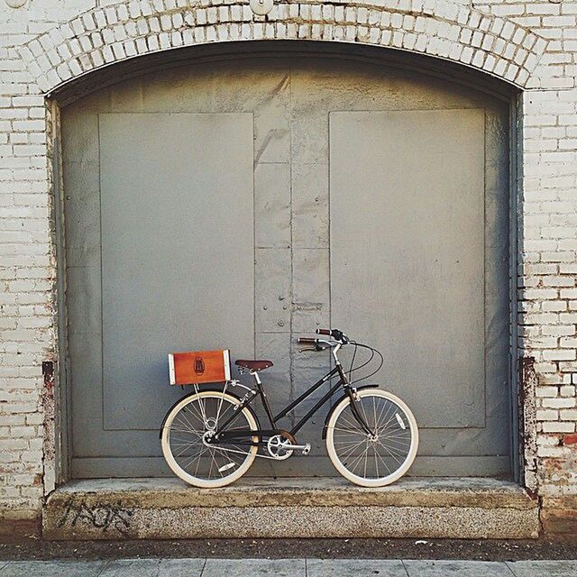 bicycle, transportation, building exterior, stationary, architecture, parked, built structure, mode of transport, land vehicle, parking, wall - building feature, brick wall, door, wall, house, window, closed, day, cycle, sidewalk