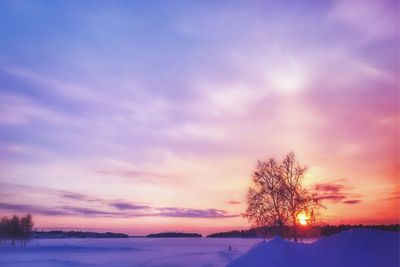 Scenic view of snow covered landscape against romantic sky