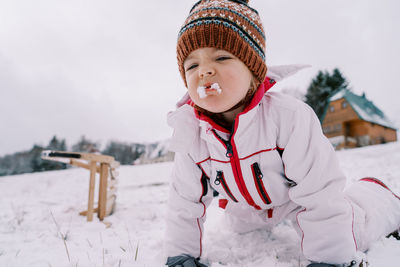 Portrait of boy standing on snow