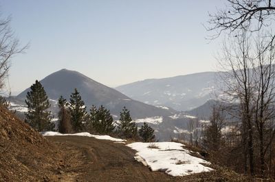 Scenic view of snowcapped mountains against clear sky