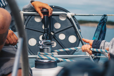 Friends mooring boat at harbor