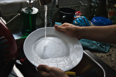 Midsection of woman preparing food in kitchen