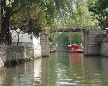 Bridge over river against trees