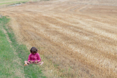 Little girl sulking in the grass