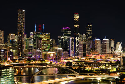 Illuminated modern buildings in city at night