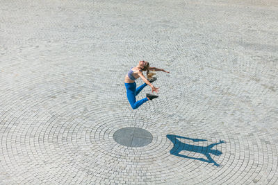 High angle view of woman standing on sand at beach