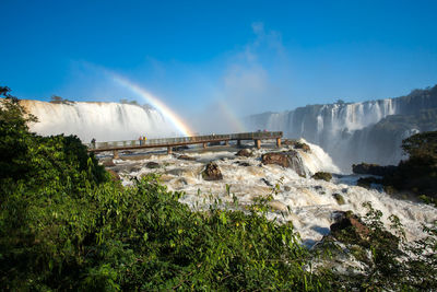 Panoramic view of waterfall against sky