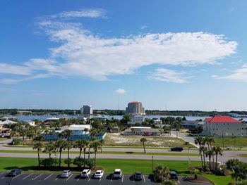 View of town by sea against sky