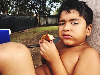 Portrait of boy eating food
