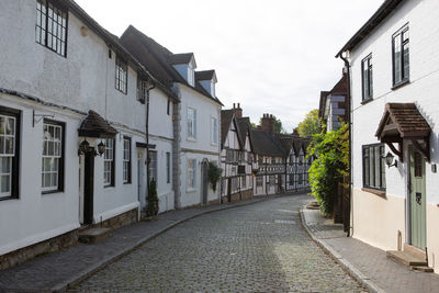 Empty alley amidst buildings in city