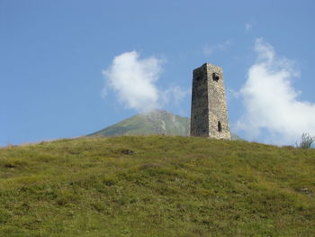 Low angle view of castle on field against sky