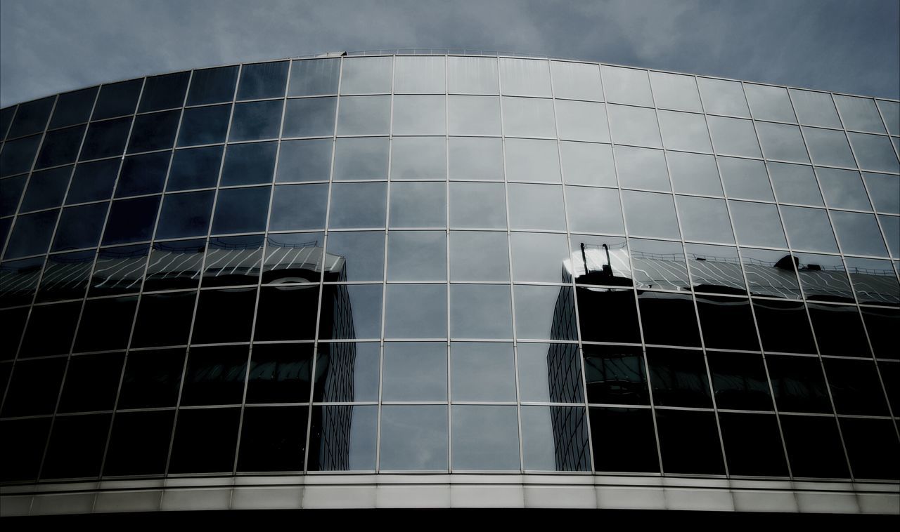 building exterior, architecture, built structure, low angle view, modern, glass - material, reflection, office building, building, window, sky, tall - high, city, skyscraper, tower, pattern, day, outdoors, no people, geometric shape