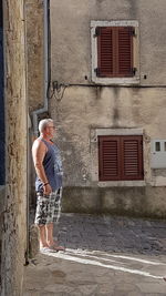 Full length of a man standing by window