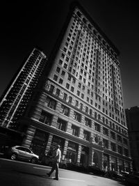 Low angle view of people walking on street at night