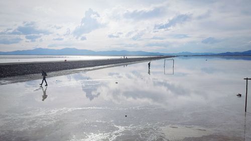 Scenic view of lake against sky during winter