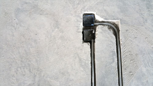 High angle view of telephone on snow on wall