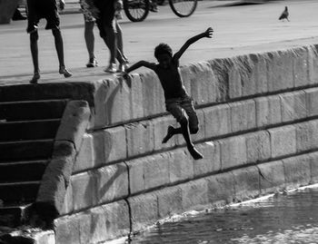 People jumping at sea shore