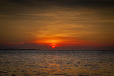 Scenic view of sea against romantic sky at sunset