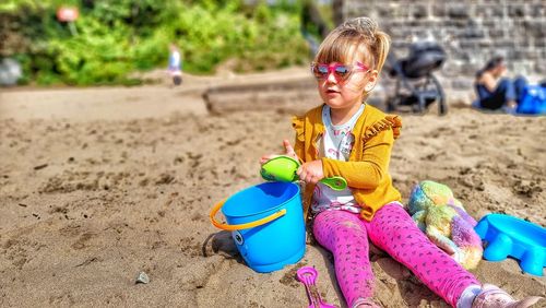 Little girl playing on the beach 