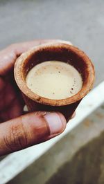 Close-up of hand holding tea cup