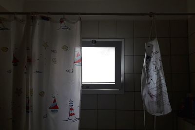 Low angle view of clothes hanging on wall at home