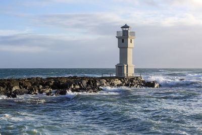 White lighthouse at the port of akranes, iceland