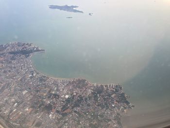 High angle view of cityscape by sea against sky