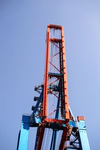 Low angle view of crane against clear blue sky