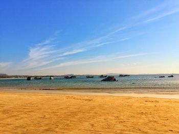 Scenic view of beach against blue sky