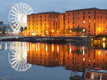 Illuminated ferris wheel at night