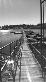 Pier over river against clear sky