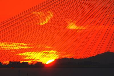 Silhouette built structure against sky at sunset