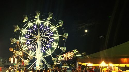 Low angle view of ferris wheel at night